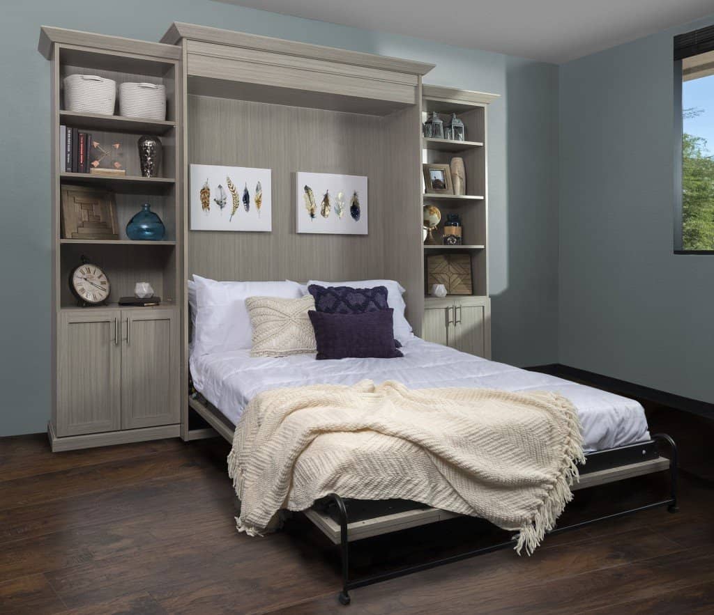 The same Murphy bed folded down and made up, with the side bookcases still in place beside it
