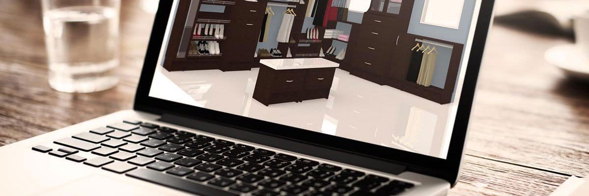 Laptop screen showing a 3D design of a walk-in closet with an island, drawers, hanging space and shoe shelves