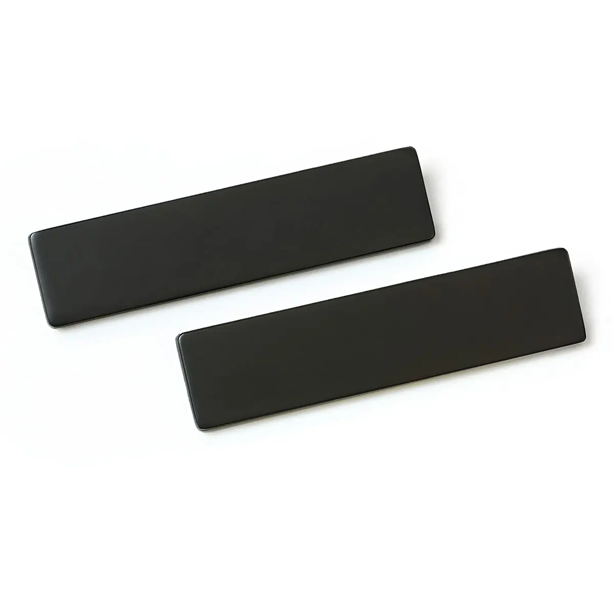 Two black rectangles are sitting on top of each other on a white surface.