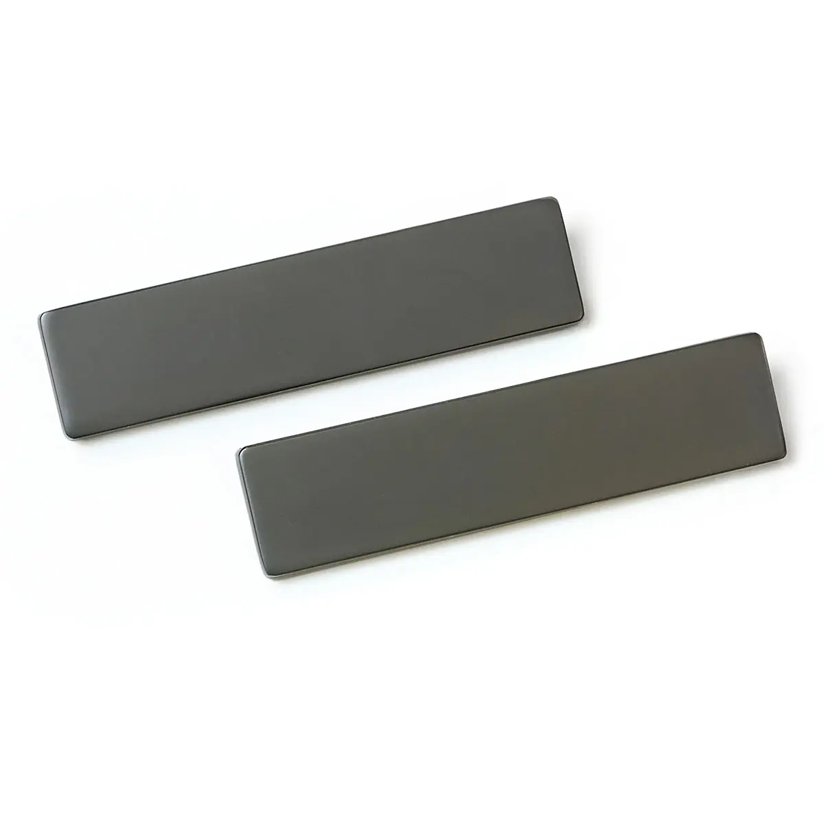 Two gray rectangles are sitting on top of each other on a white surface.