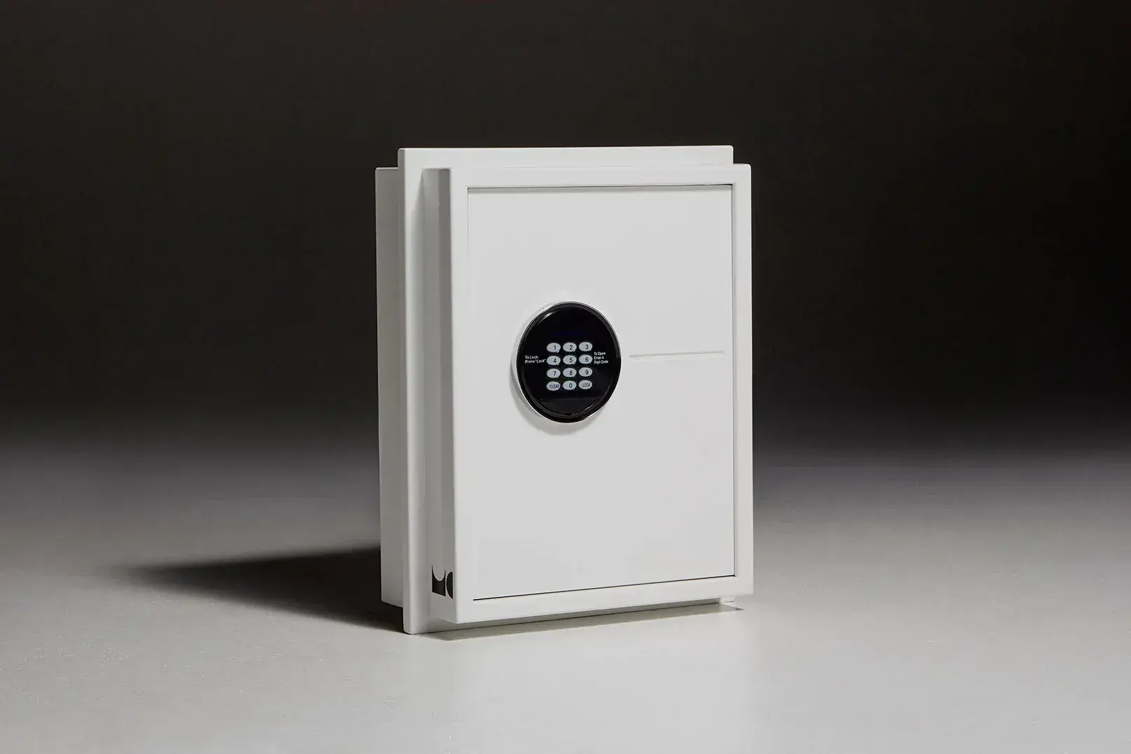 A white safe with a digital lock is sitting on a table.